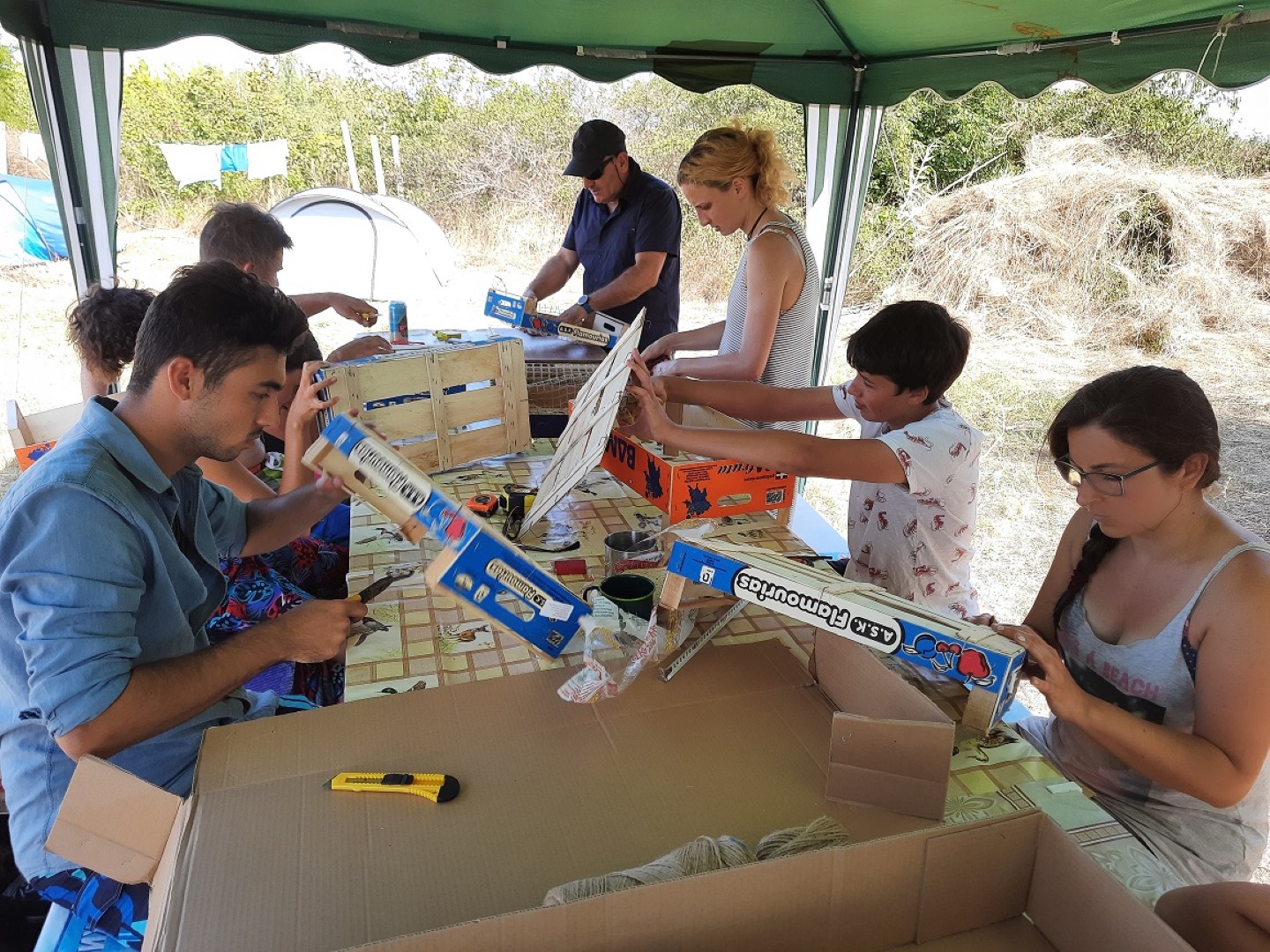 a group of volunteers constructing boxes